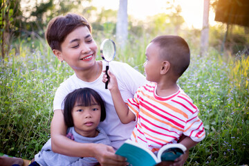 Kids exploring in forest with a magnifying glass