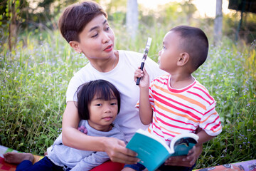 Kids exploring in forest with a magnifying glass