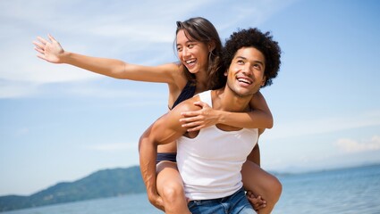 Happy couple piggyback ride on beach summer vacation travel lifestyle concept image