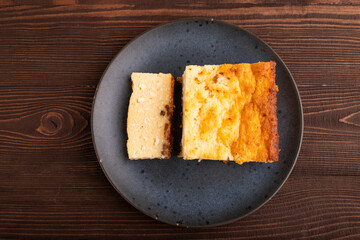 Сottage cheese Сasserole, Curd cake, with dried apricots and raisins on brown wooden, top view, copy space