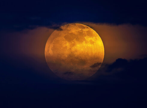sunrise on the strawberry full moon with clouds from the front.

