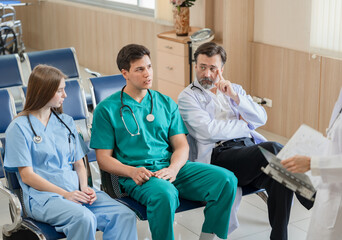 Team Doctor listening medical student present at hospital	