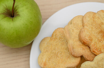 whole grain biscuits on a plate with a green apple, diet