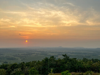 A breathtaking view of a golden sunrise from the hill in Indonesia.  