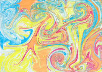 Abstract ebru background. Bright iridescences of paint on the water. A creative artistic background for graphic design. Yellow, pink, blue, orange shades. The fluid texture of colors. Contemporary art