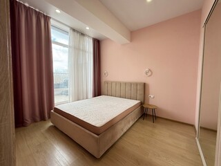 Modern Bedroom with Pink Accent Wall and Balcony View