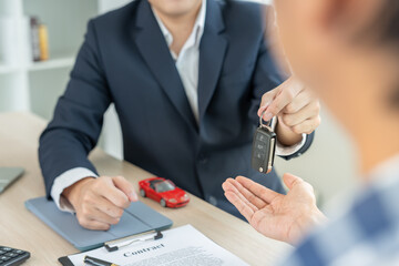 lease, rental car, sell, buy. Dealership manager send car keys to the new owner.  Sales, loan...