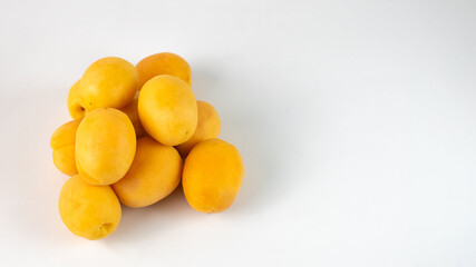 a pile of apricots on a white background