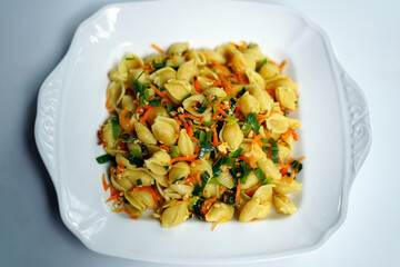 Colorful Veggie Pasta Served in Elegant White Bowl Isolated on White