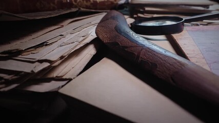 Mystery documents and artefacts on treasure hunters desk in moody room