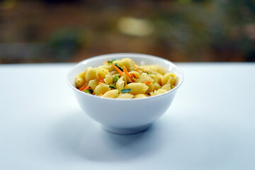 White Bowl of Vegetarian Pasta on White Minimal Background