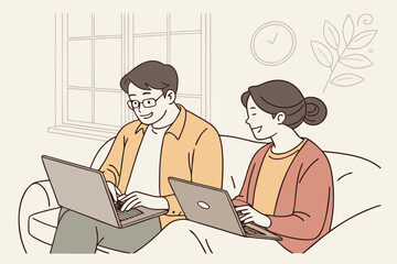 Two people working together on laptops in a cozy indoor space with a relaxed atmosphere during a sunny afternoon