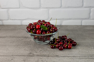 cherries in a transparent bowl on the kitchen table