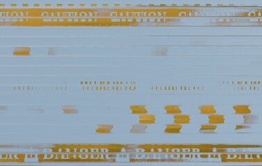 Abstract image featuring repeating horizontal bands of blurred text, predominantly 