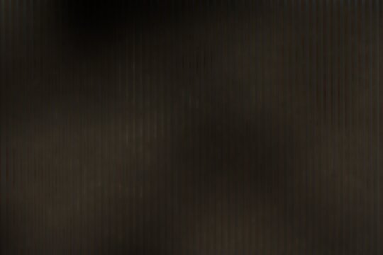 A blurred, dark brown image depicting a corrugated texture.  The vertical lines are slightly out of focus, creating a hazy, almost metallic appearance.  The overall tone is muted and shadowy