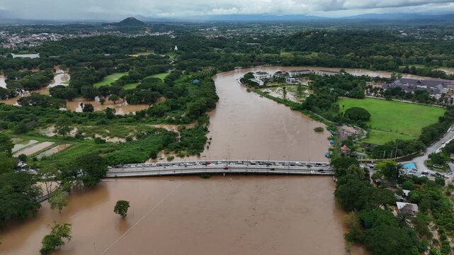 Aerial view of car evacuate on the Mae Fah Luang bridge in Chiang Rai province of Thailand after Kok river rising and flood dwntown.