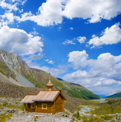 small wooden christian church stay in green mountain valley
