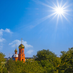 christian church among green park at the summer sunny day