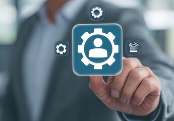 Businessperson's hand interacting with a digital interface featuring a person-in-gear icon