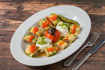 Beyti kebab rolled in lavash with yogurt, tomato sauce and grilled tomato