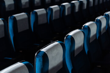 Blue chairs in an empty movie theater, low light