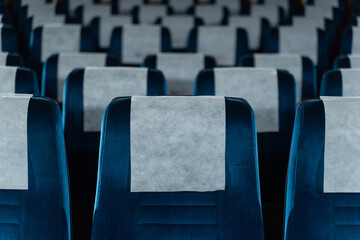 Blue chairs in an empty movie theater, low light