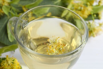 Close-up of green tea with linden in transparent cup