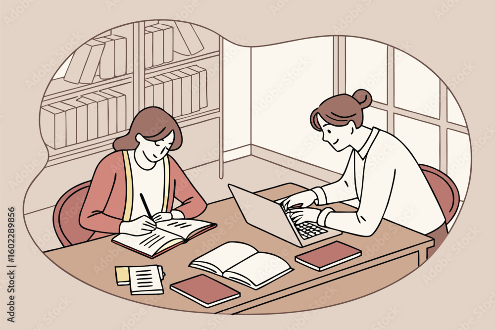 Poster students studying together at a library table, sharing notes and working on laptops during a collabo