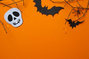 Black bats, skull, spider and decorative branches. Happy Halloween. Top view, space for text