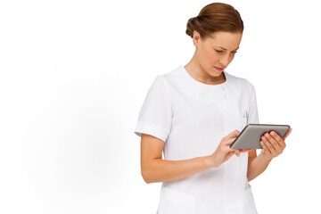 Fototapeta premium Female healthcare professional wearing medical uniform holding digital tablet in studio, copy space