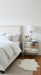 A bright and airy bedroom featuring a bed, nightstand, and decor.