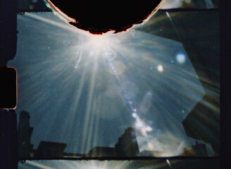 Light leaks and flares creating an artistic overlay on 8mm film background