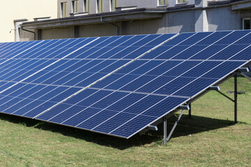 Blue solar panels generating clean renewable energy on a sunny day, showcasing sustainable...