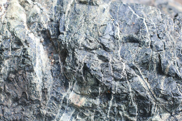 Close-up view of marble stone relief showcasing textured surface details with subtle grooves,...