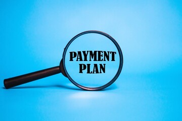 PAYMENT PLAN in the middle of the magnifying glass. beautiful light blue background.