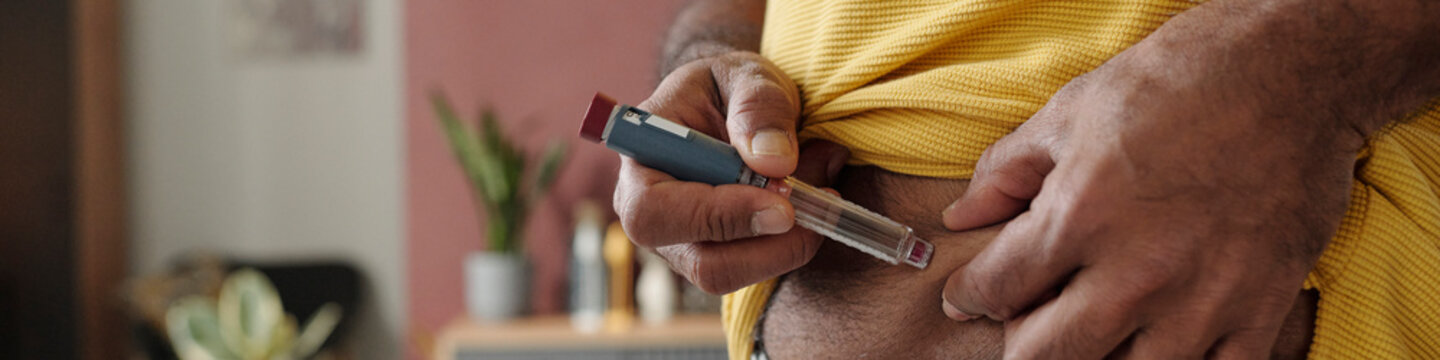 Diabetic person using insulin pen for self care at home