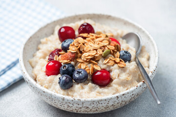Oatmeal porridge with berries and granola topping