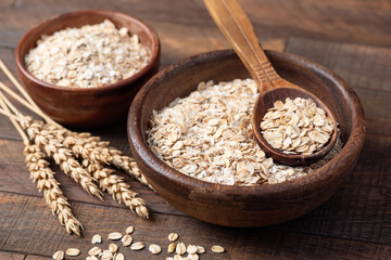 Dry Rolled Oats In Woodean Bowl Top View. Uncooked Oatmeal