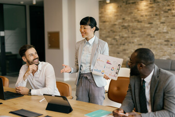 Confident business professional presenting statistics at team meeting