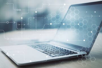 Laptop with digital abstract interface and hexagonal patterns on light tech background representing modern data and futuristic technology concept.