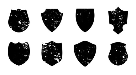 Set of vintage grunge shield shapes with distressed texture and blank space isolated on white background perfect for retro labels stamps and badge designs.