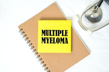 Multiple Myeloma on a sticky note on a notebook. Clean white background. Doctor's stethoscope.
