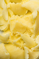The texture of small broken pieces of frozen yellow ghee butter. Background for cookbook