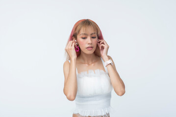 Young Asian woman adjusting or changing earrings