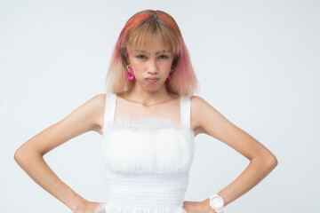 Annoyed young Asian woman with hands on hips