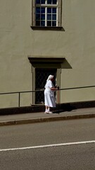 young woman standing in front of a building