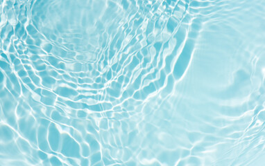 Blue water with ripples on the surface. Defocus blurred transparent blue colored clear calm water surface texture with splashes and bubbles. Water waves with shining pattern texture background.