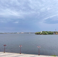 View from the embankment of the city of Dnipro to Monastyrsky Island surrounded by the dark waters...