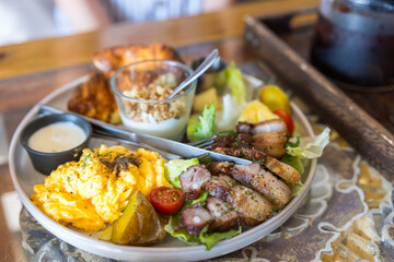 Healthy brunch meal with egg and grilled meat