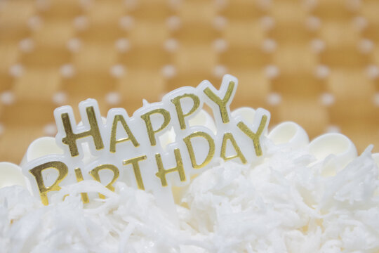 Golden Happy Birthday Cake Topping Over Coconut Frosted Dessert